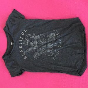 A gray short sleeved shirt .